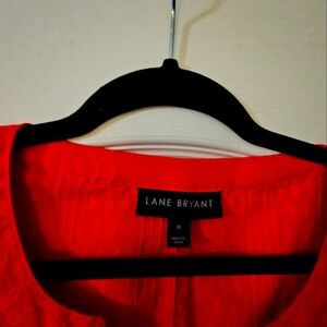 A coral long sleeve blouse with a tie front from Lane Bryant.